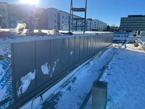 Before, the worn screen wall (Rooftop Screen Wall & Security Mesh, Denver Tech Center)